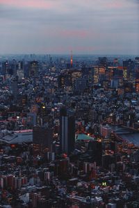 High angle view of illuminated cityscape against sky at dusk