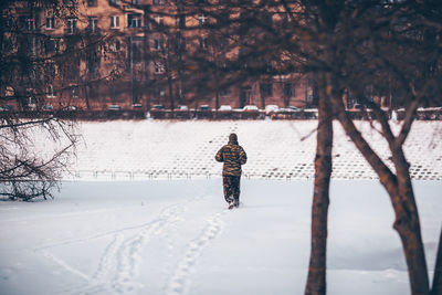 Rear view of man on snow covered land