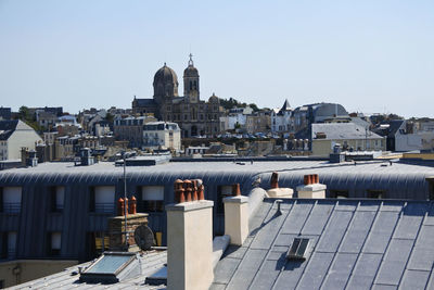 Buildings in city against clear sky