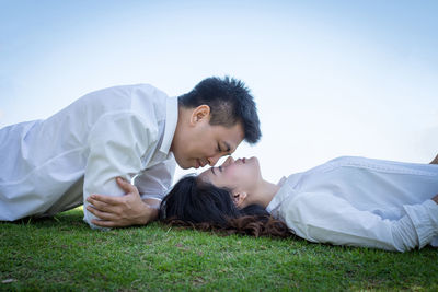 Young couple lying on grass