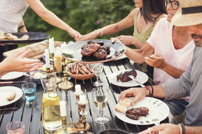 High angle view of people enjoying lunch in garden party at back yard