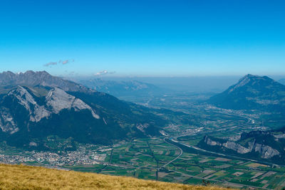 Scenic view of mountains against clear blue sky