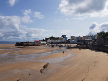 Panoramic view of beach and buildings against sky