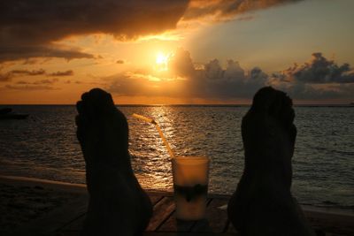 Silhouette people at beach during sunset