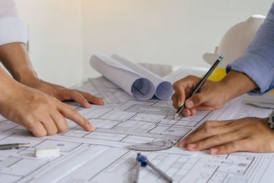 Midsection of man working on table