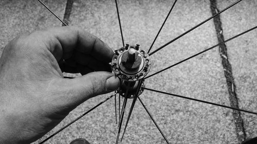 Close-up of male hand touching bicycle wheel hub