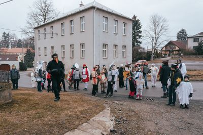 People standing on street against buildings in city