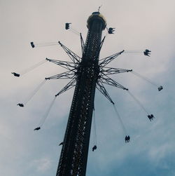 Low angle view of ferris wheel against sky