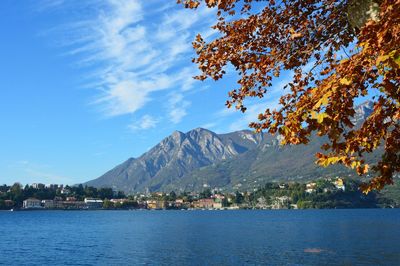 Scenic view of sea and mountains against blue sky