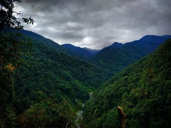 Scenic view of mountains against cloudy sky