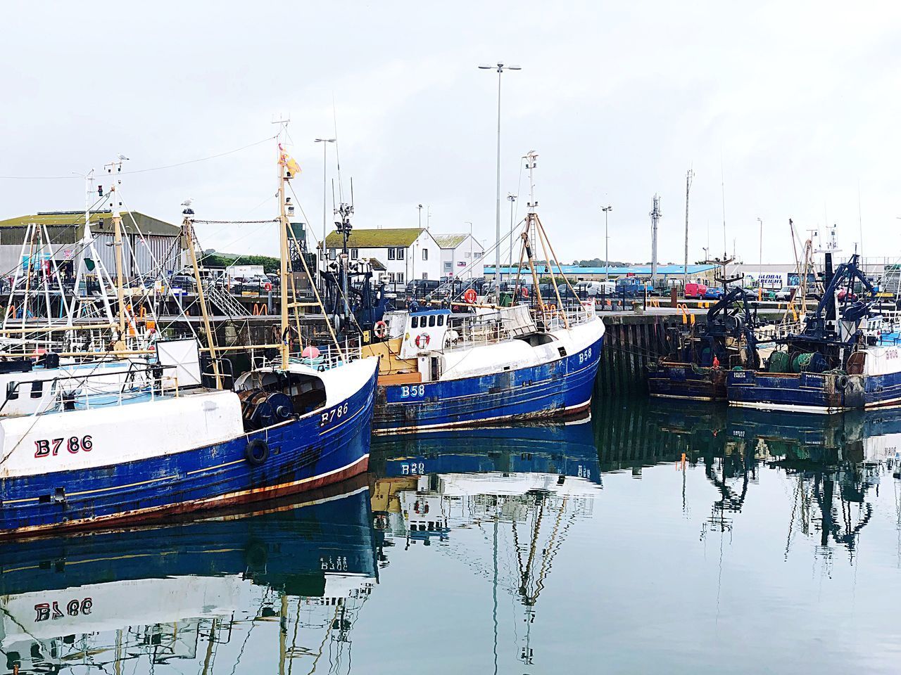 BOATS MOORED IN HARBOR