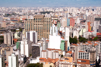 High angle view of modern buildings in city against sky