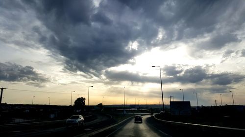 Road passing through dramatic sky