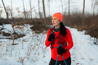 Young woman standing on field during winter