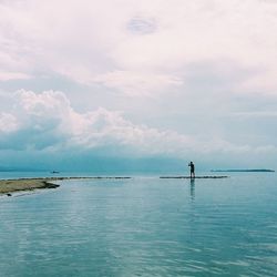 Scenic view of sea against cloudy sky