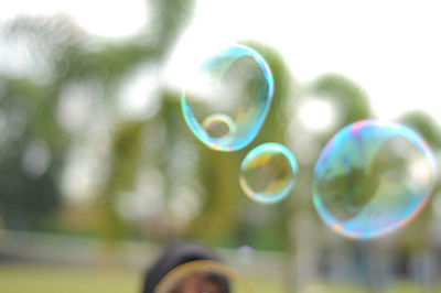 Close-up of bubbles against rainbow