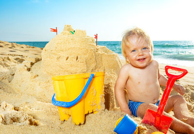 Portrait of boy playing with toy on beach