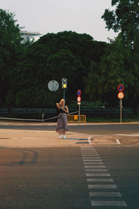 Full length of man skateboarding on road against sky