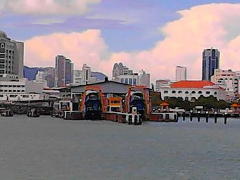 Buildings against cloudy sky at sunset