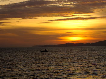 Scenic view of sea against orange sky