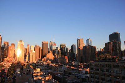 Illuminated city against clear sky