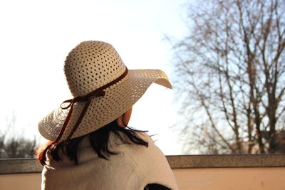 Rear view of woman wearing hat against sky