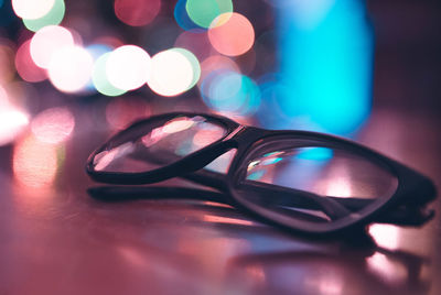 Close-up of sunglasses on illuminated eyeglasses