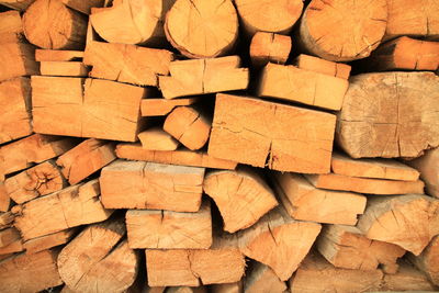 Full frame shot of stack of logs in forest