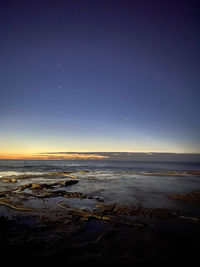 Scenic view of sea against sky at night