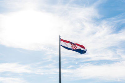 Low angle view of flag against sky