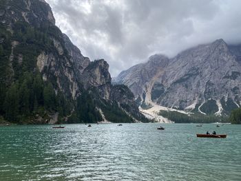 Scenic view of lake by mountains against sky