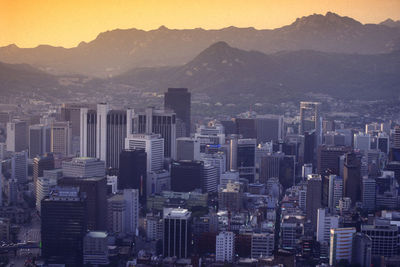 Aerial view of buildings in city against sky