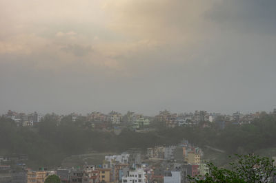 High angle view of buildings in city against sky