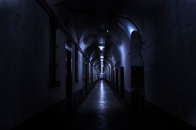 Empty illuminated corridor in dark building