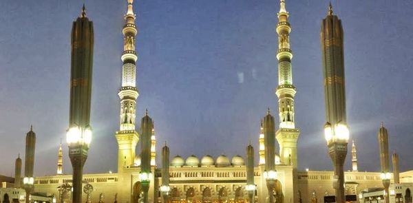 Panoramic view of illuminated buildings in city against sky