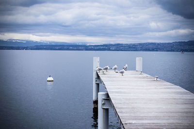 View of pier on sea against cloudy sky