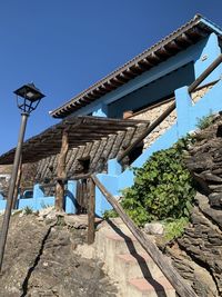 Low angle view of old building against clear blue sky