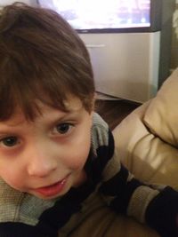 Close-up portrait of smiling boy at home