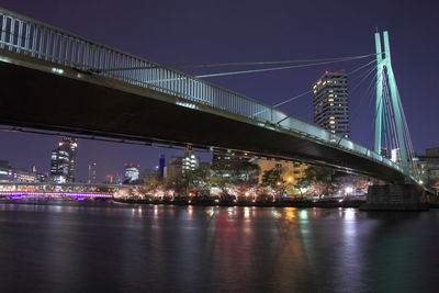 City lit up at night with bridge