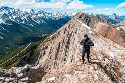 Full length of man on rock in mountains