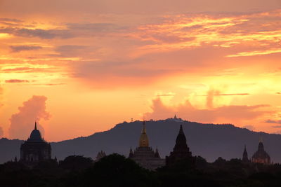 Silhouette temple against sky during sunset