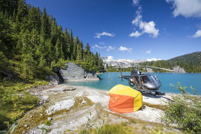 Helicopter passengers evacuate and test out emergency shelter on beach