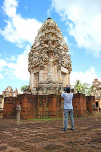 Rear view of man standing against temple