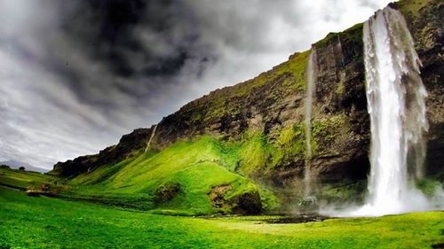 Scenic view of landscape against cloudy sky