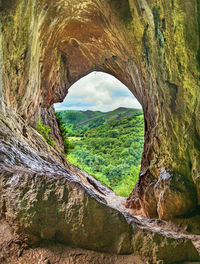 Scenic view of rocky landscape seen through hole