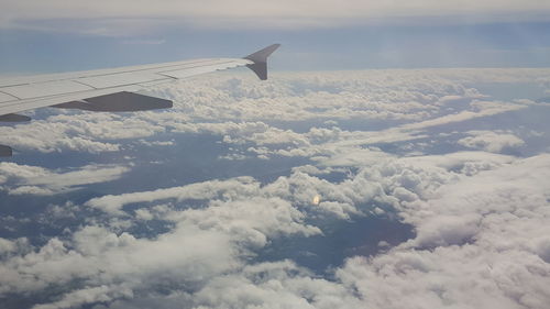 Aerial view of cloudscape over airplane wing