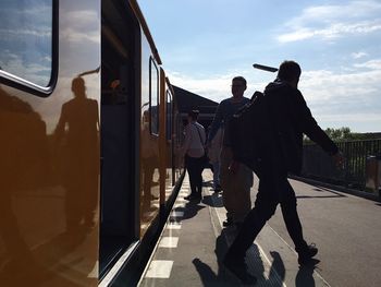 People walking on railroad station platform