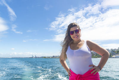 A woman on top of a boat against the sea in the background. salvador, bahia, brazil.