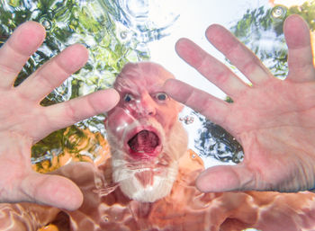 Close-up portrait of man holding hands