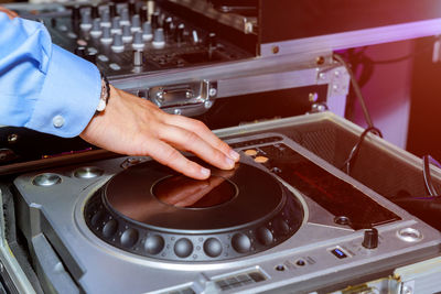 Cropped image of hand on sound recording equipment